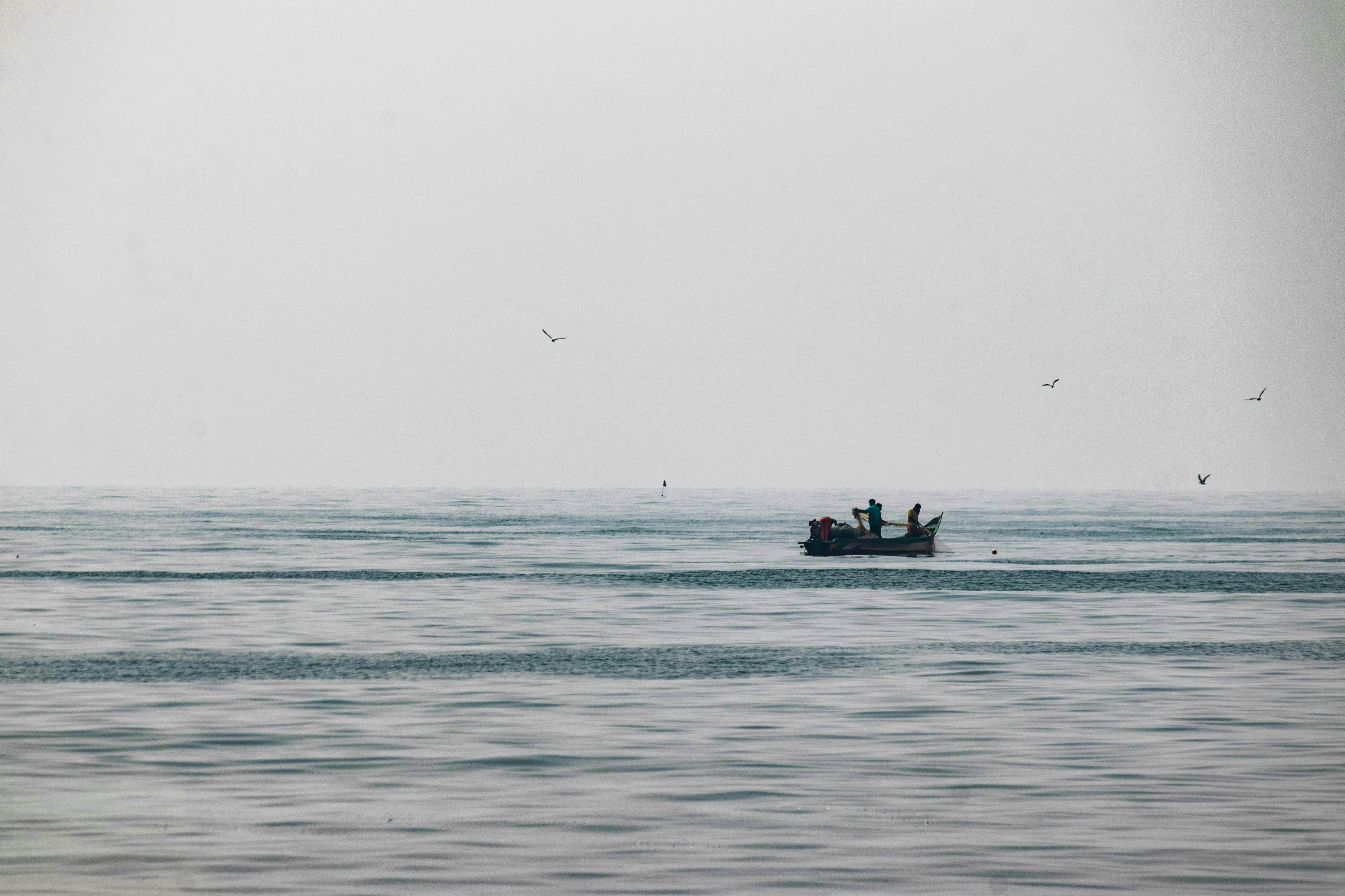 artisanal fishing boat in distance 
