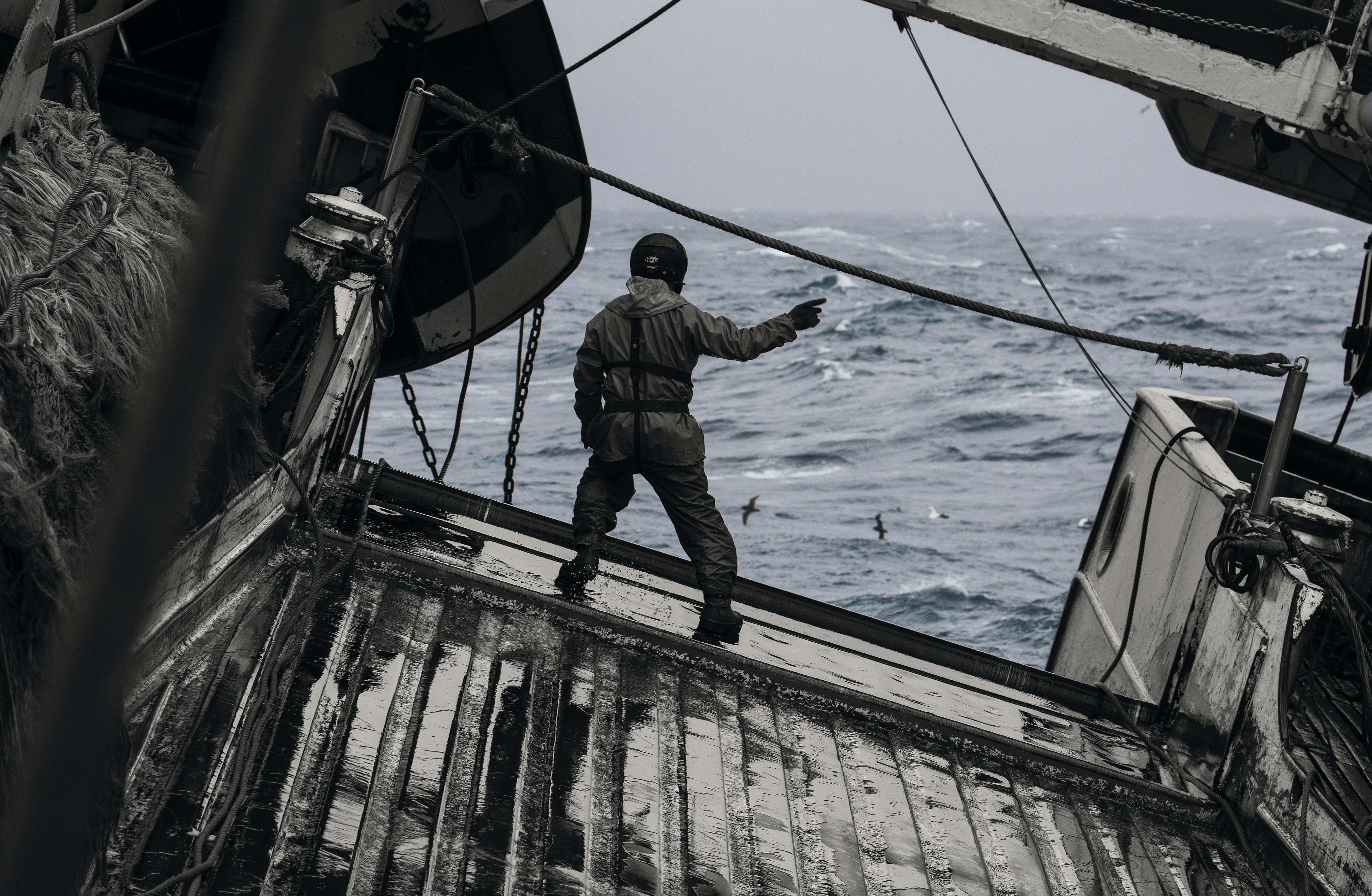 man on fishing boat in rough seas