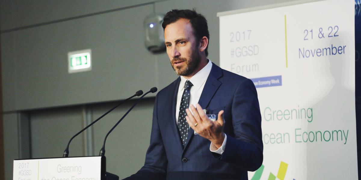 Christopher Costello speaking at a podium