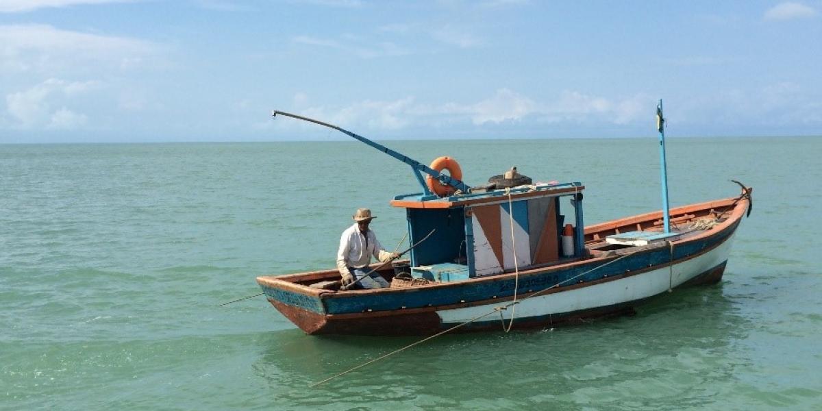 fishing boat floating by itself on the open sea