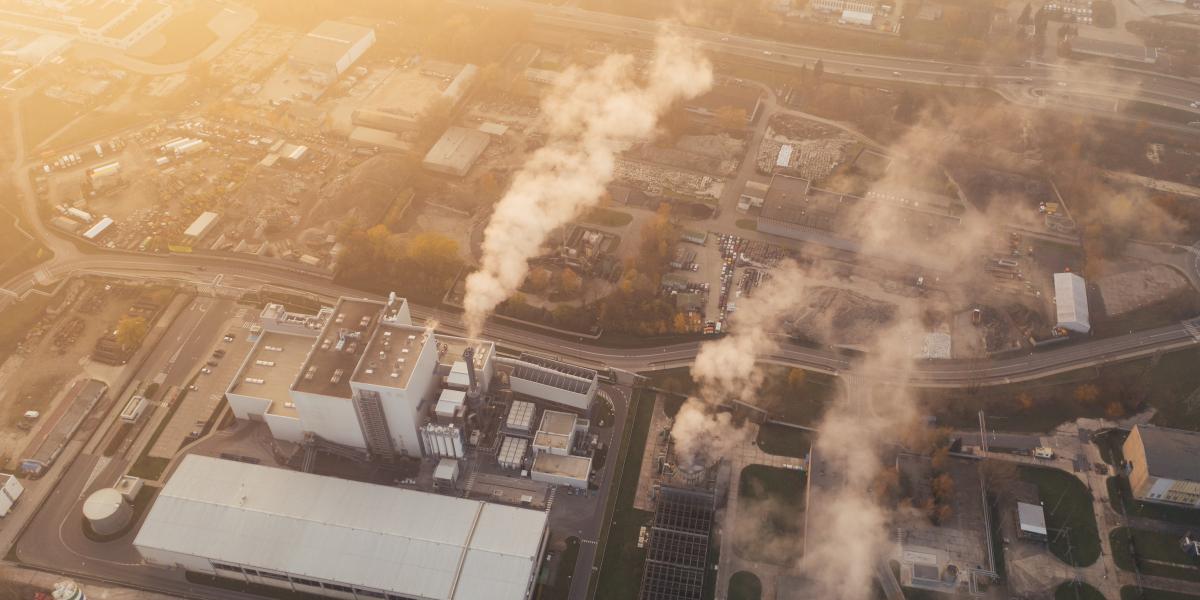 aerial view of a factory with smoke coming out