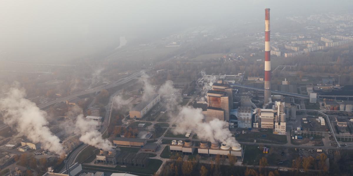 aerial view of factories emitting smoke
