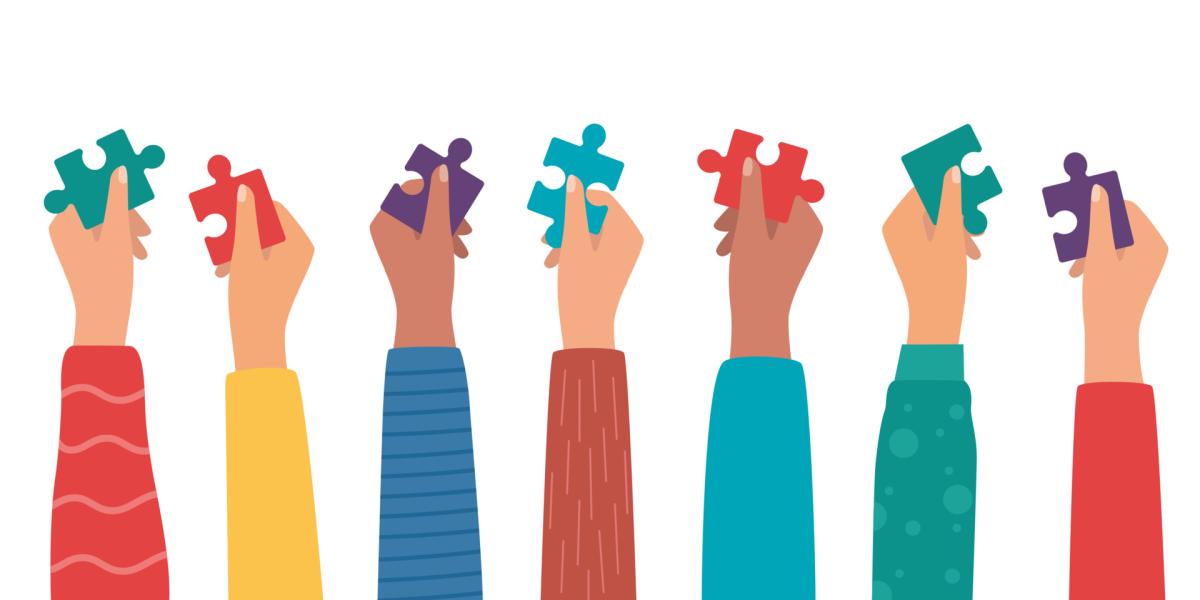 people's hands holding puzzle pieces