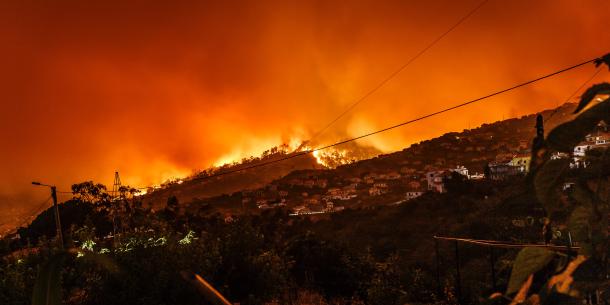 wildfire on hillside near homes