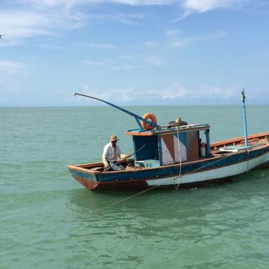 fishing boat floating by itself on the open sea