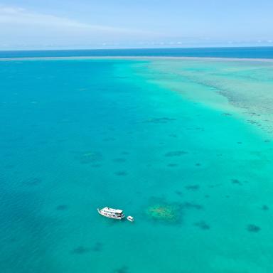 aerial of reef with recreational boat
