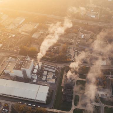 aerial view of a factory with smoke coming out
