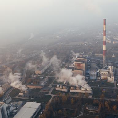 aerial view of factories emitting smoke