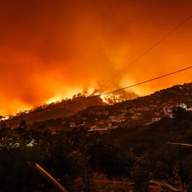 wildfire near houses on hillside