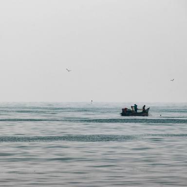 artisanal fishing boat in distance 