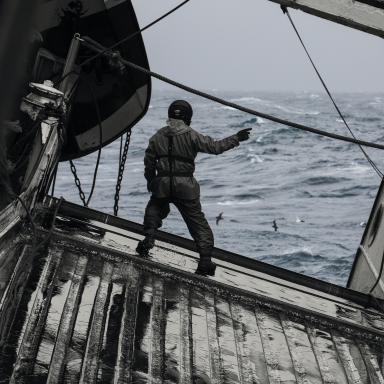 man on fishing boat in rough seas