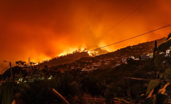 hillside fire behind houses